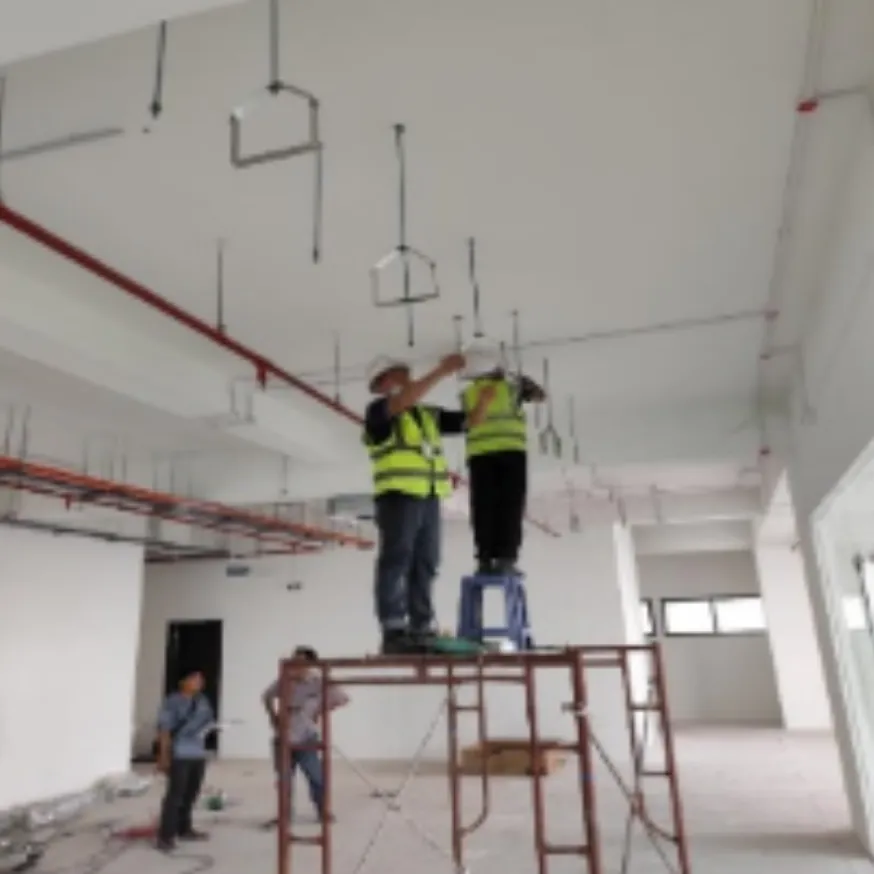 SBG installers fitting pipework and units under a ceiling